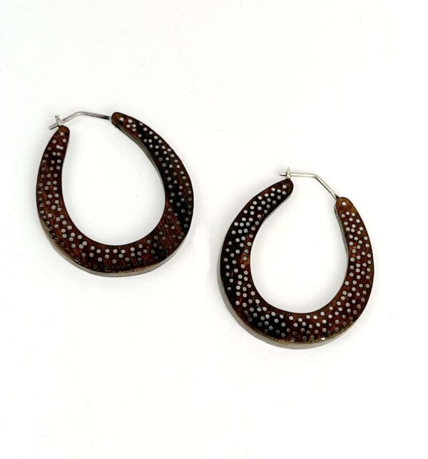 A pair of brown and black earrings on a white background