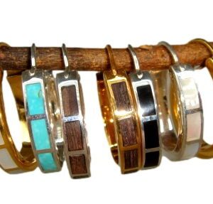 A wooden rack holding several bracelets of different colors.