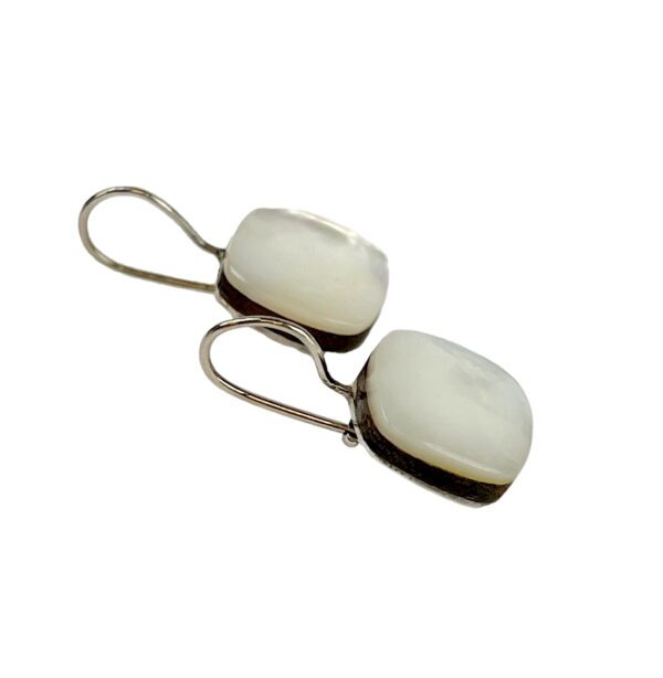 A pair of silver earrings with white stones.