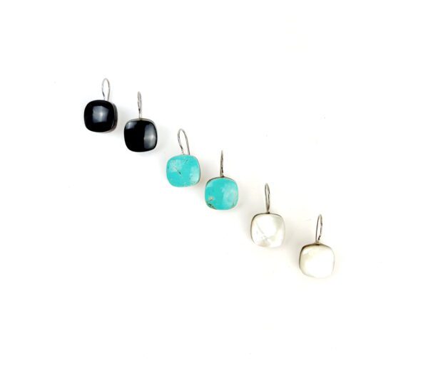 A row of different colored earrings on top of each other.