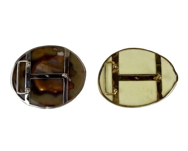 A pair of round buckles with metal plates.