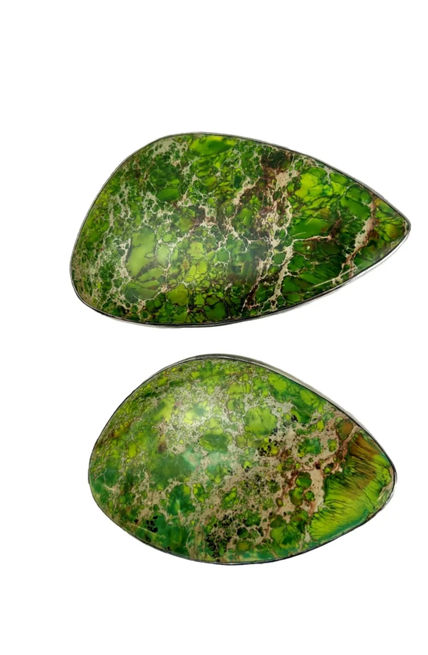 Two green stones are sitting side by side.