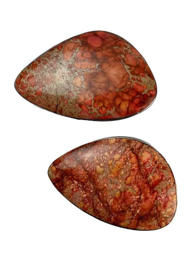 A pair of red and orange stones are sitting on top of each other.