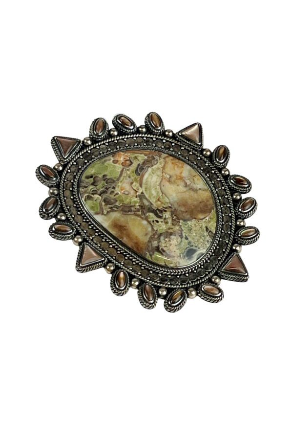 A picture of an ornate stone brooch.