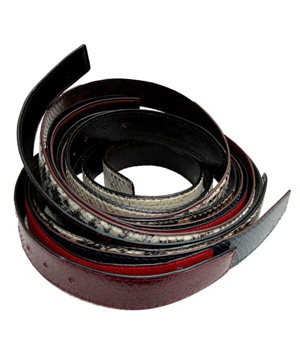 A pile of leather straps that are curled up.