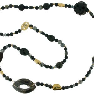 A long necklace with black beads and gold accents.